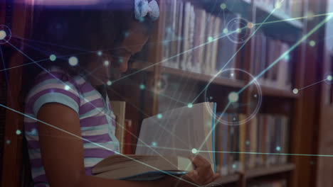 animation of network of connections over biracial school girl reading book in library