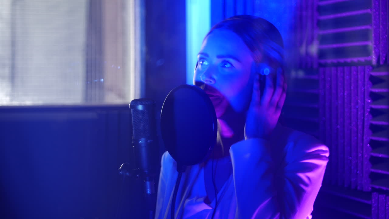 A singer recording a song in a music studio