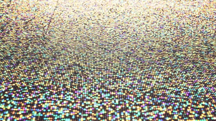 Close-up motion showing thousands of tiny rectangular iridescent tiles across flat horizontal surface, with shimmering highlights, shifting glow, soft reflections, and rich decorative color