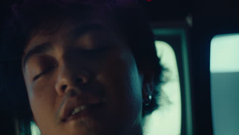 portrait close up of young alternative male sleeping and dreaming with cat tv on background