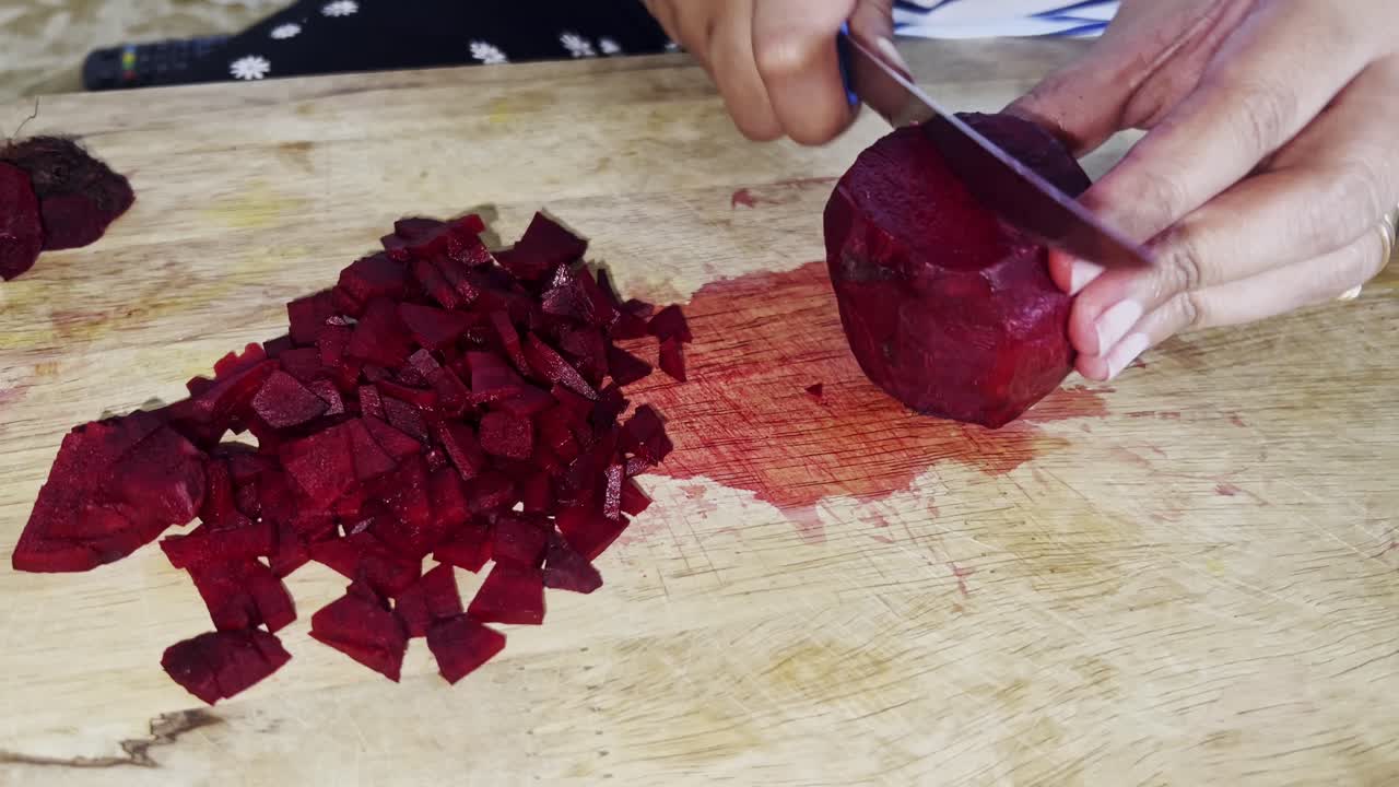 Clean cooking. Woman cutting fresh beetroot in protective gloves, close up