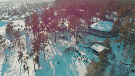 mountain top with ski resort and people on track upper view