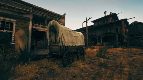 an abandoned western town with a covered wagon in the foreground