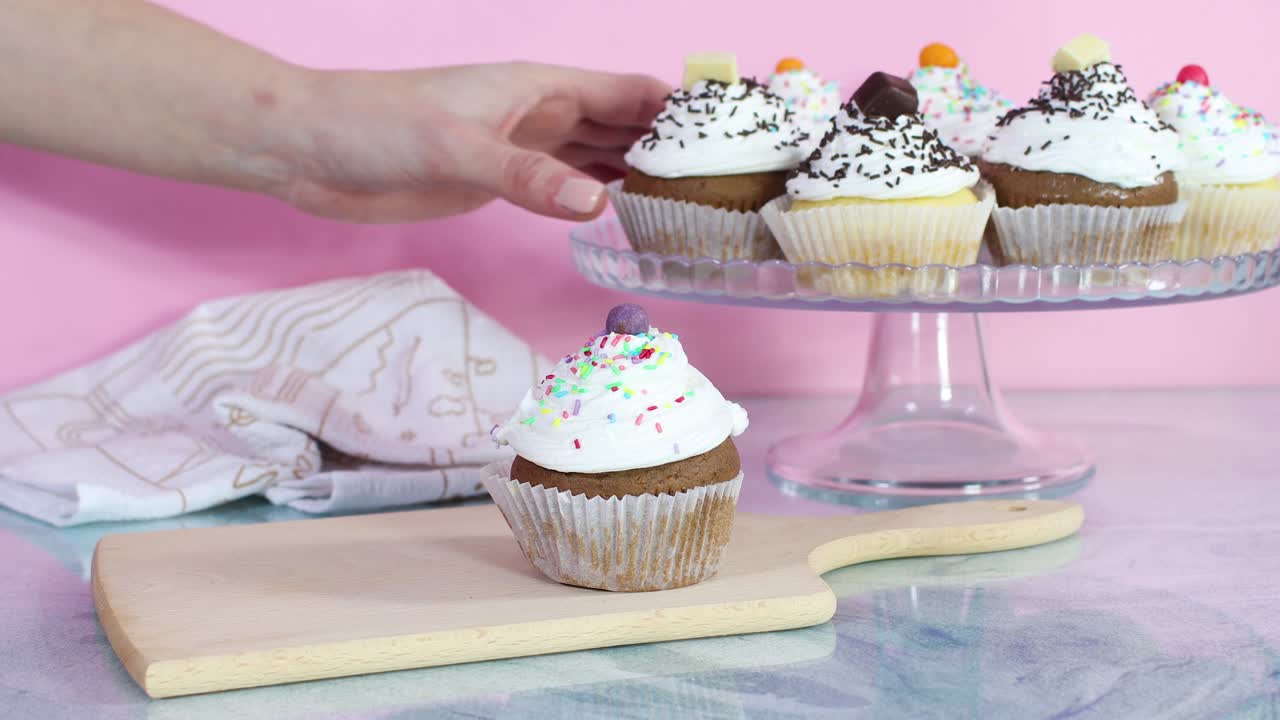 Servizio di deliziosi cupcake dal piatto sul tagliere.
