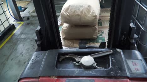 forklift loading bags in industrial warehouse