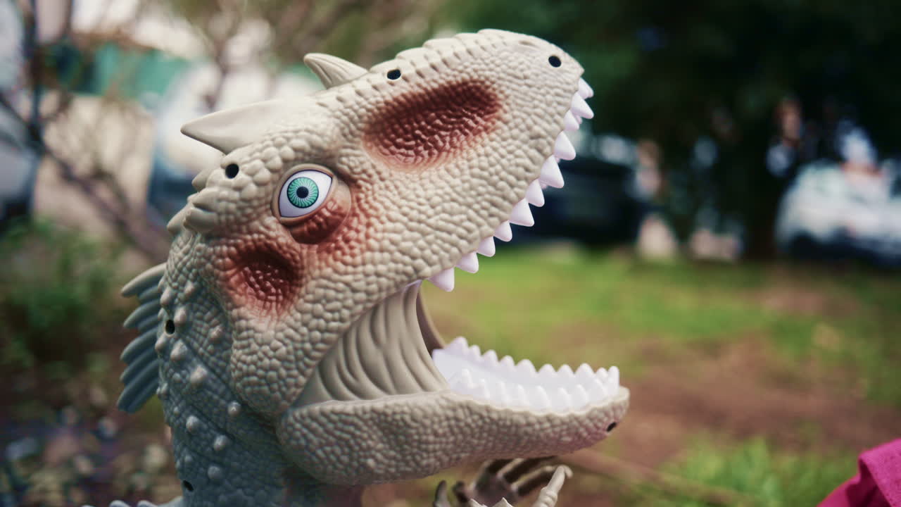 Close up shot of a textured dinosaur toy outdoors in a park