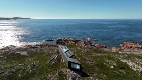 joe batt's point trail overlooking long studio modern architecture on fogo island from an aerial orbital drone shot, newfoundland, canada