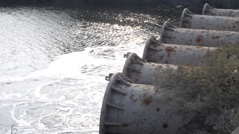 side view of row of large industrial discharge pipes in karachi