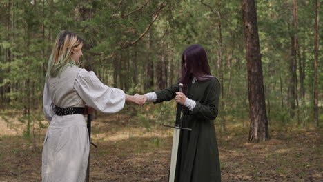 girls shake hands before sword fight