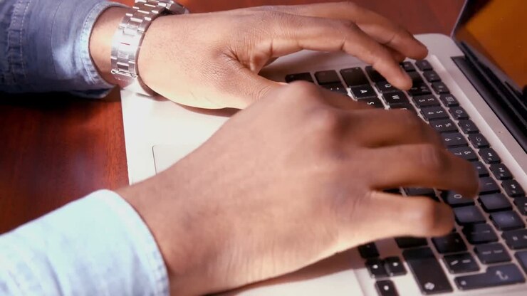 Mans hands using laptop