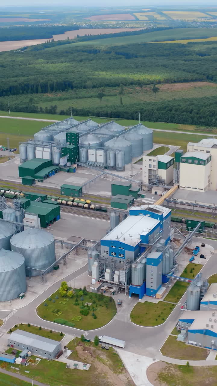 Agricultural huge metal factory storages. Big territory of farming storage warehouses. Vertical video