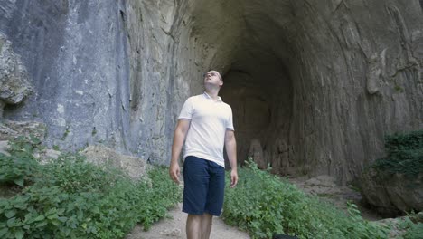 male tourist at the famous karst cave of prohodna near karlukovo, north central bulgaria