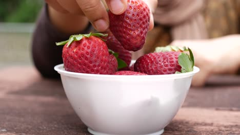 woman eating strawberries