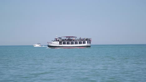 people on boat in lake passing by beach