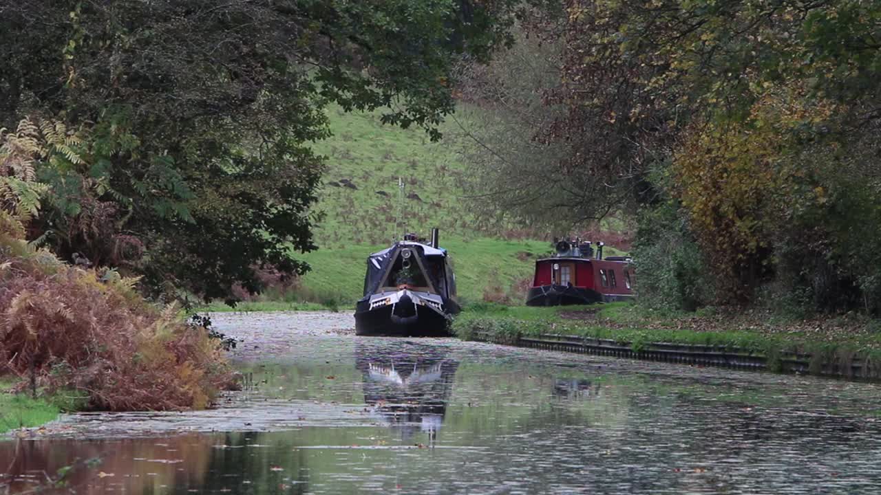The Staffordshire and Worcestershire Canal in early Autumn with two barges moored to the Bank. Near Kinver. Staffordshire. UK