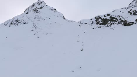 Person-free-skiing-down-a-large-snowy-mountain