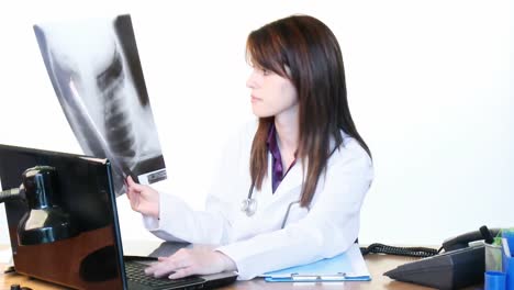 brunette doctor examining an xray in hospital