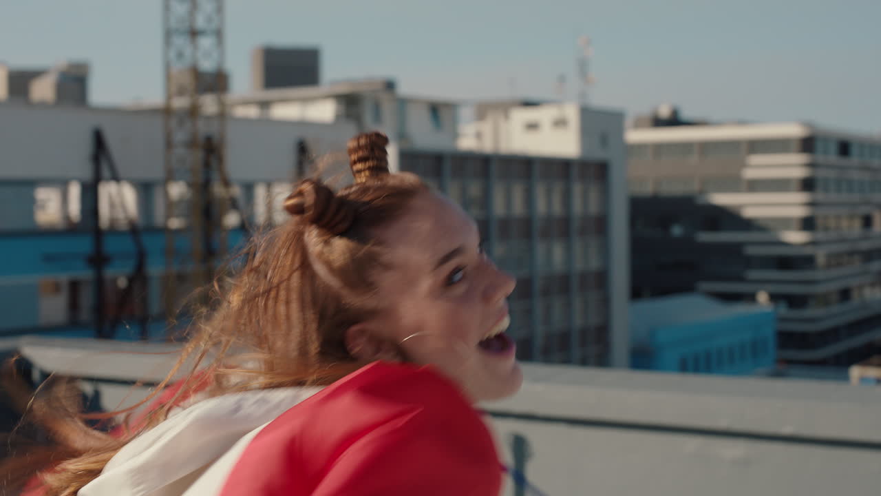 happy woman dancing on rooftop celebrating enjoying silly dance having fun crazy dancer girl in city