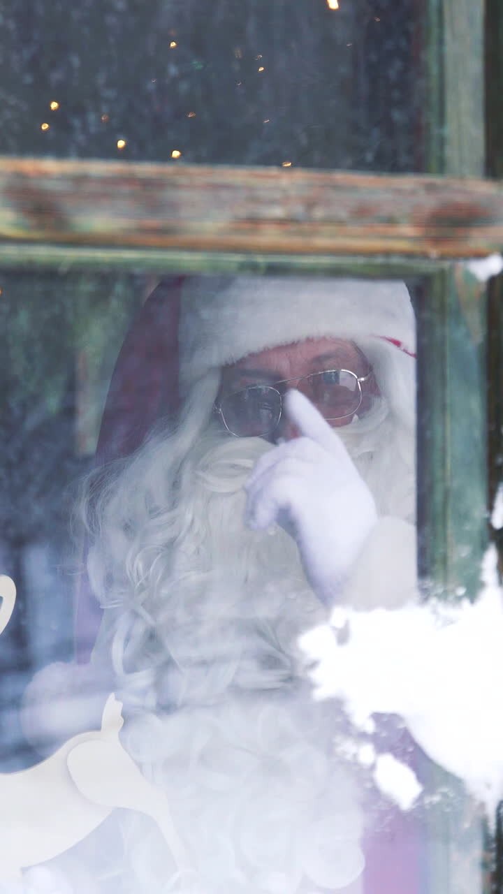 Santa Claus inside the house at window. Snowball is broken into the window and Santa quarrels showing hand gestures. Vertical video