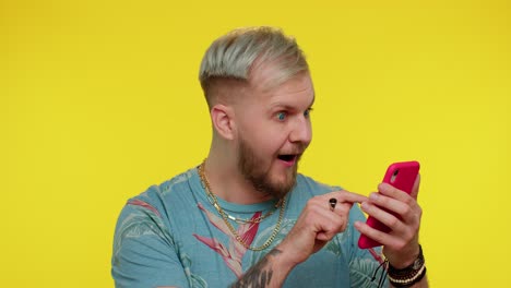 happy excited man use mobile phone say wow yes found out great big win news doing winner gesture