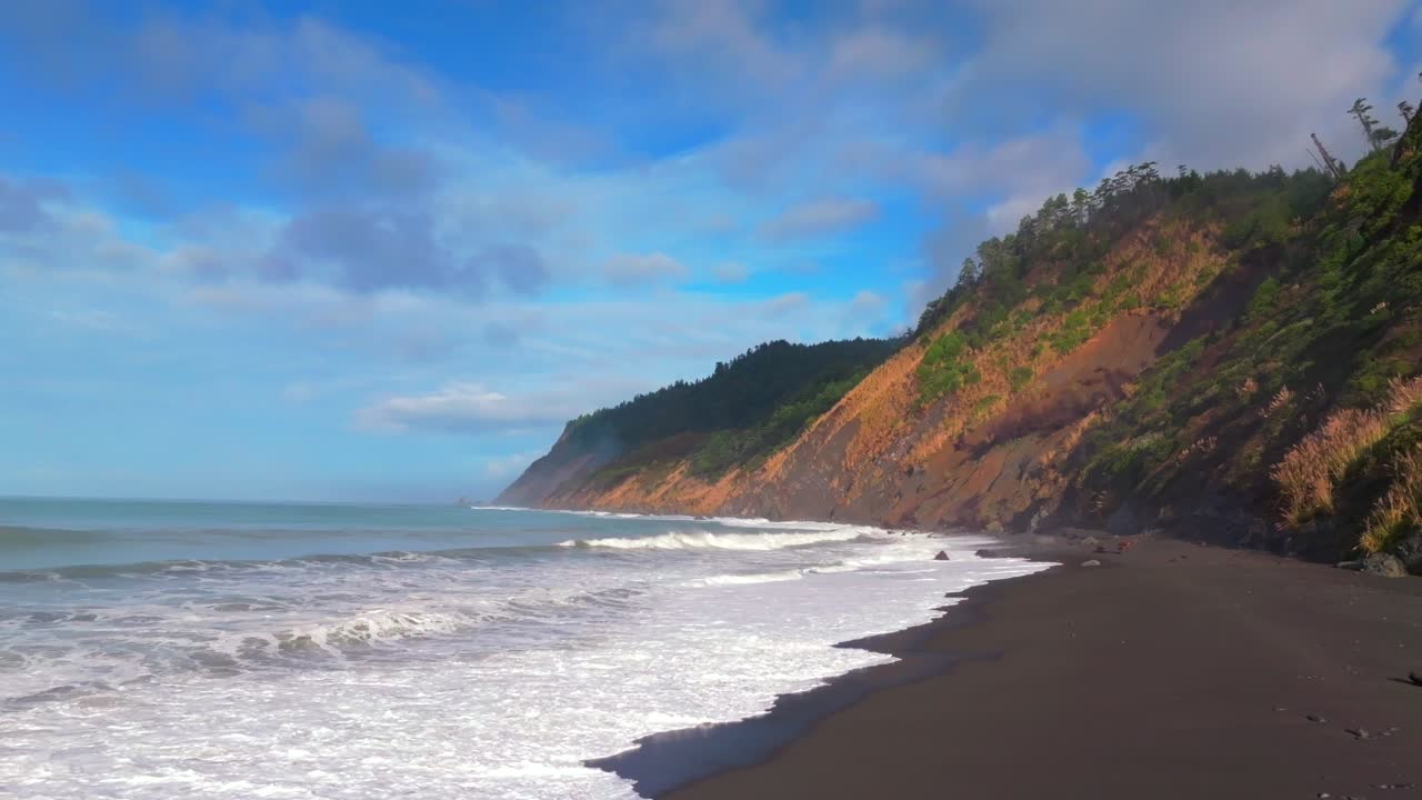 Sunny morning blue sky surf tide waves USAL Beach campground PNW Lost Coast Trail aerial drone California rugged dramatic untouched coastline mist fog clouds nature landscape forward pan up motion