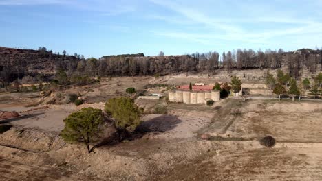 aerial shot of a drone going to a rural house