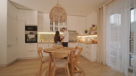 loving couple making a sandwich in kitchen-living room