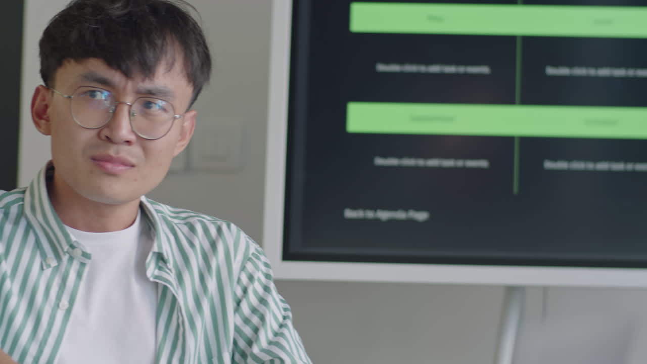 Young Asian Man Speaking with Colleague on Business Meeting