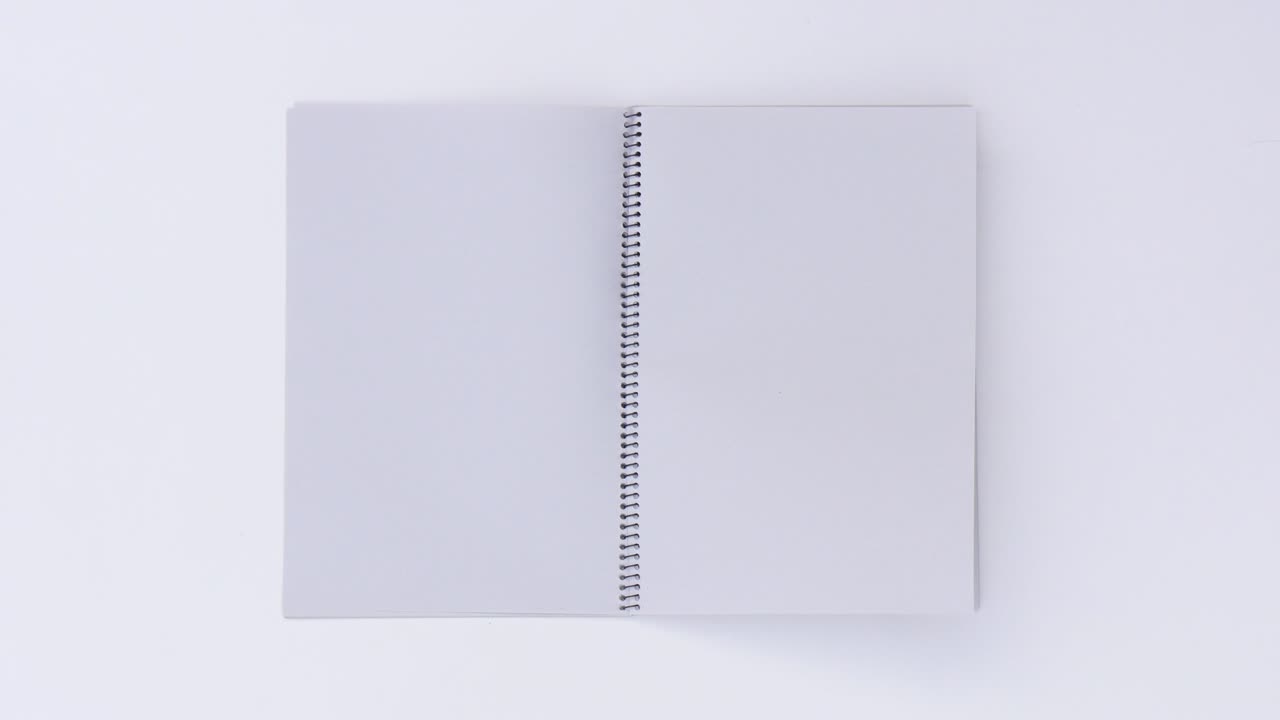 Turning page binder book by wind on a white background