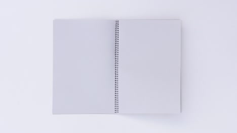 turning page binder book by wind on a white background