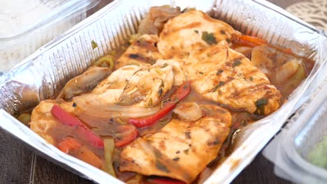 grilled chicken with vegetables in takeout containers