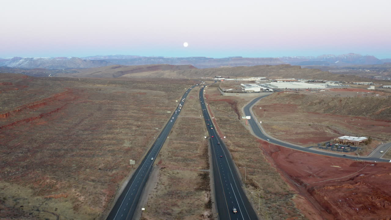 Aerial View of Desert Highway with Full Moon at Twilight