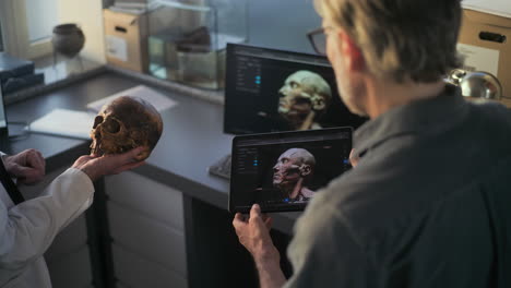 scientists analyzing a 3d model of a skull