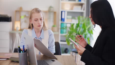 Confident-Female-Office-Workers-Discussing-in-Office