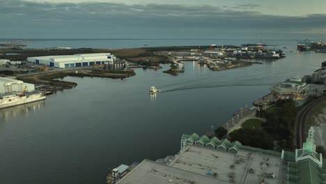 Aerial-view-of-push-boat-sputtering-along-in-Mobile-River-Mobile-Alabama