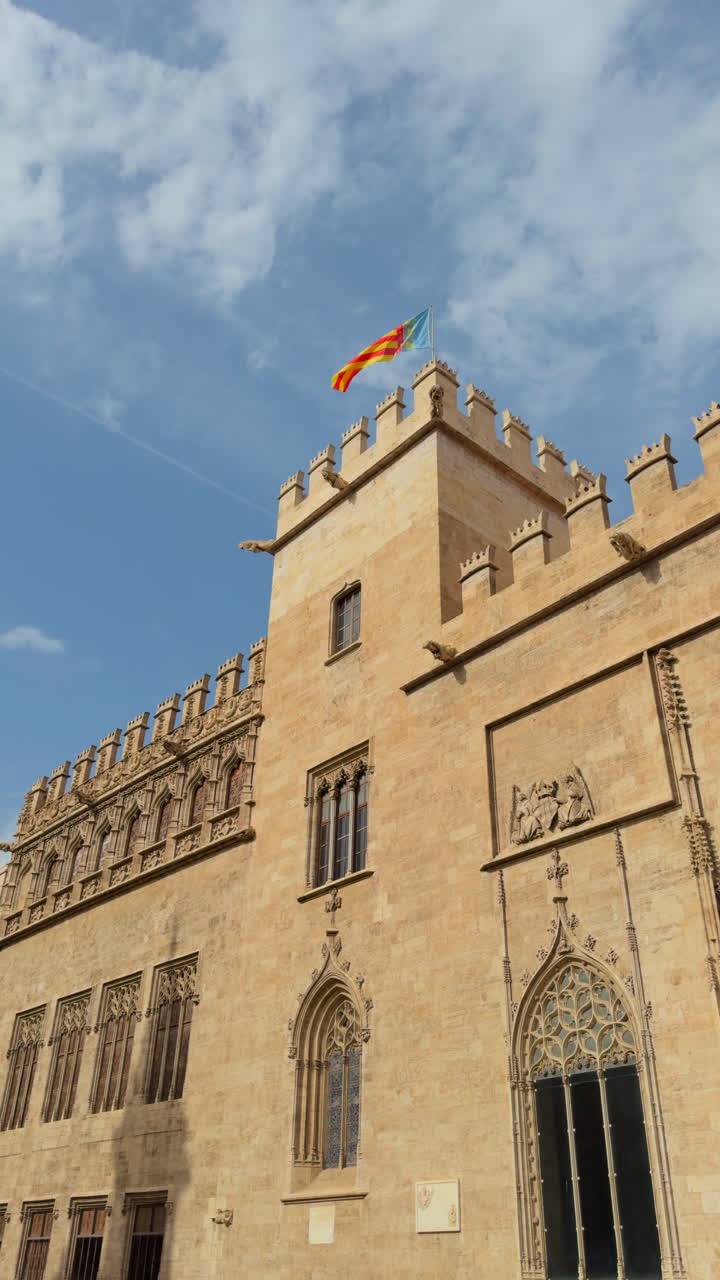Silk Exchange (Lonja de Seda) in Valencia, Spain, with the Valencian flag flying atop the historic Gothic building