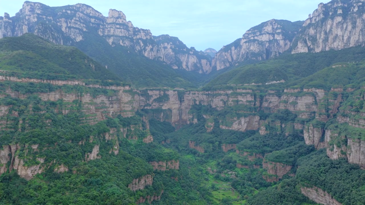 Aerial panorama of magnificent Taihang Mountains grand canyon with steep layered rock cliffs, natural geological landforms in China