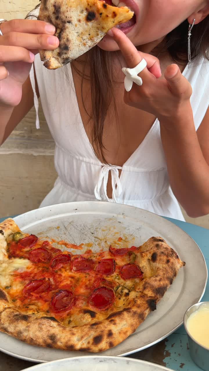 Woman eating Neapolitan pizza