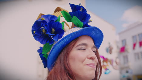 girl at festa dos tabuleiros tomar portugal smiling using a traditional hat