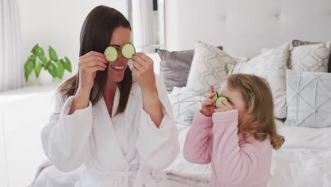 Caucasian-mother-and-daughter-having-fun-in-bedroom