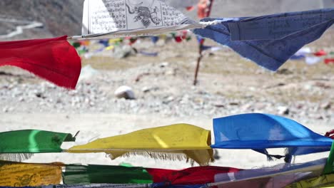 colorful buddhist prayer flags blow by the wind - close up