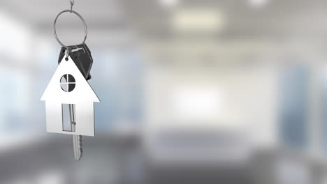 animation of silver key with house key fob and copy space over out of focus interiors