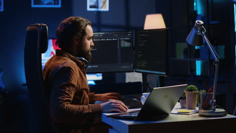 software technician typing code in neon lit personal office