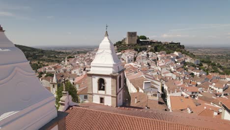 white bell towers of church igreja matriz de santa maria da devesa, castelo do vide, portugal