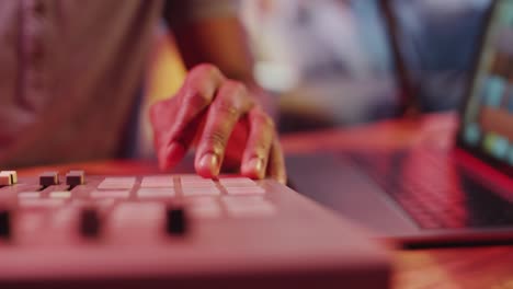 hands of male sound producer working on mixing console in recording studio