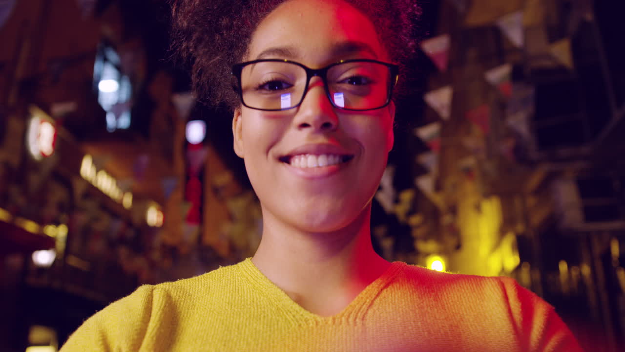 la ciudad nocturna sonríe a una mujer joven.