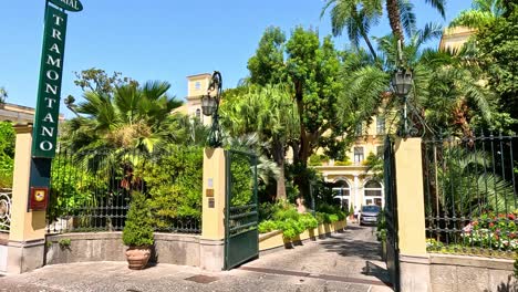 gate opening to lush hotel entrance