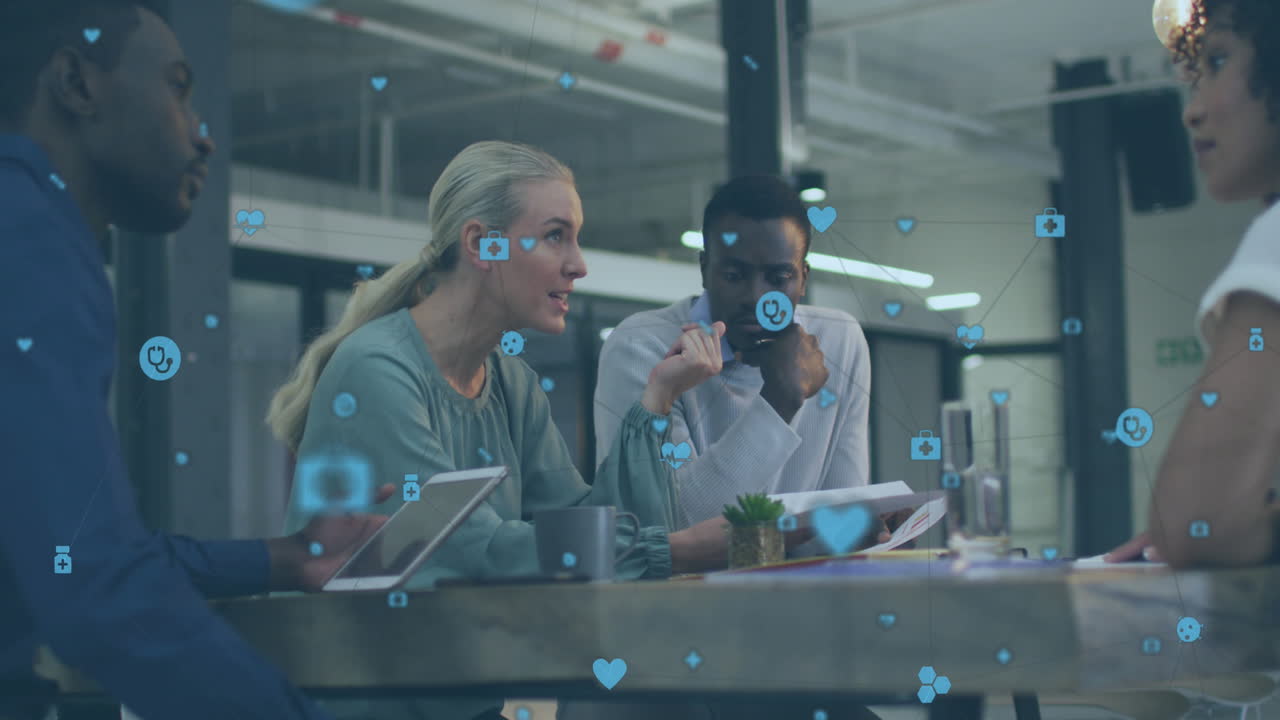 Animation of network of digital icons against diverse colleagues discussing together at office