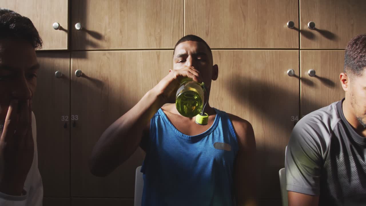 Soccer player drinking water in the locker room