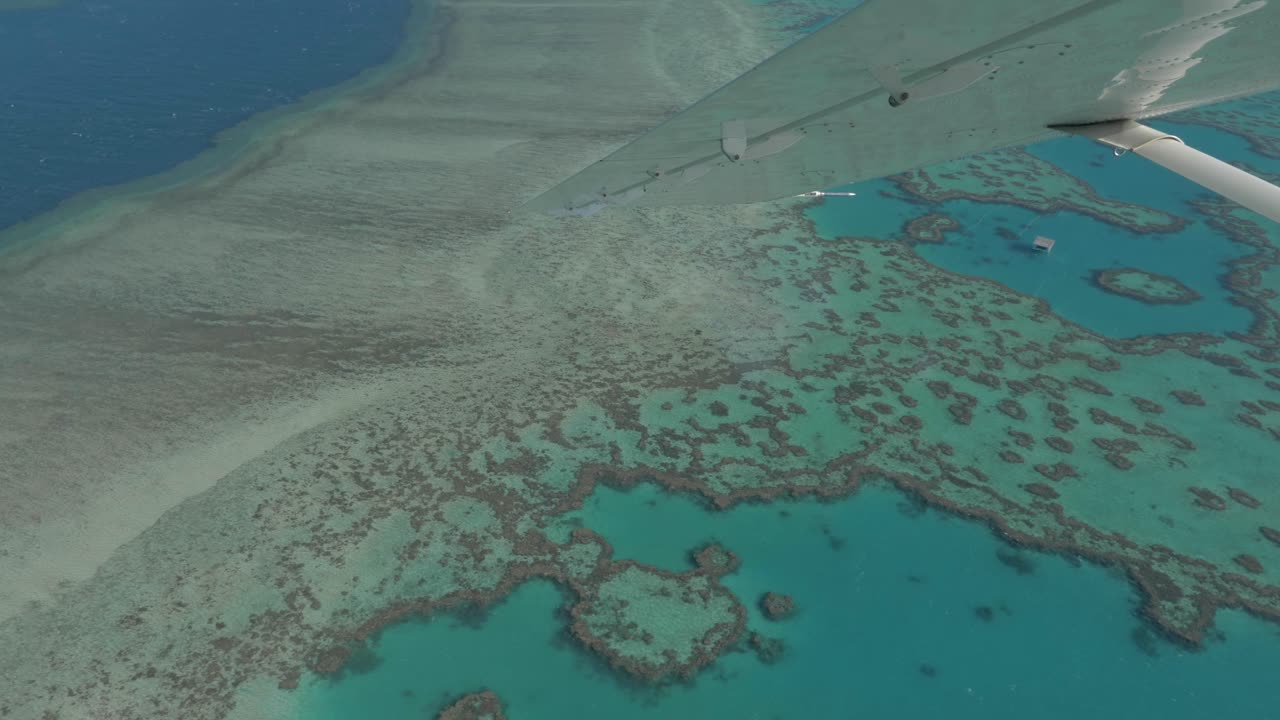 Great Barrier Reef With Clear Water Adjacent To The Queensland Coastal Areas - View From Airplane Window